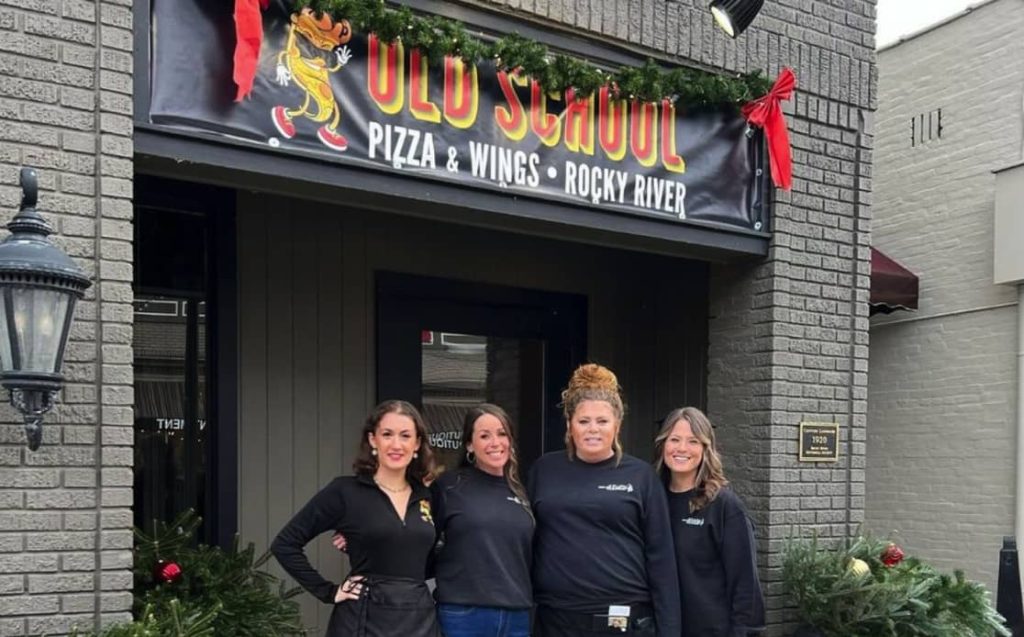 employees stand in front of old school pizza and wings by parker's in rocky river, oh