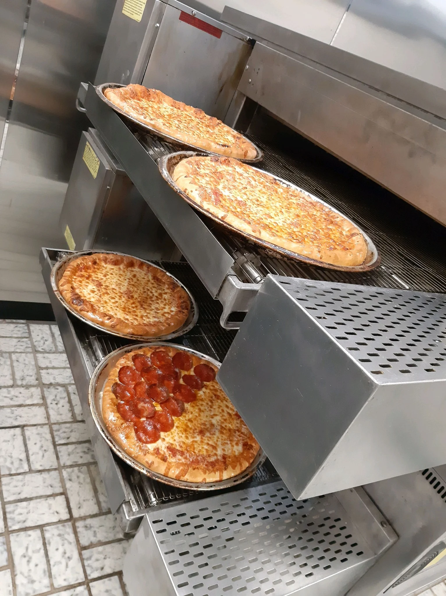 pizzas sitting on pizza oven
