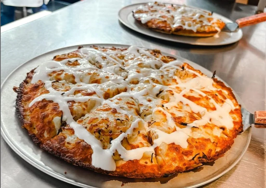close-up of two freshly baked pizzas